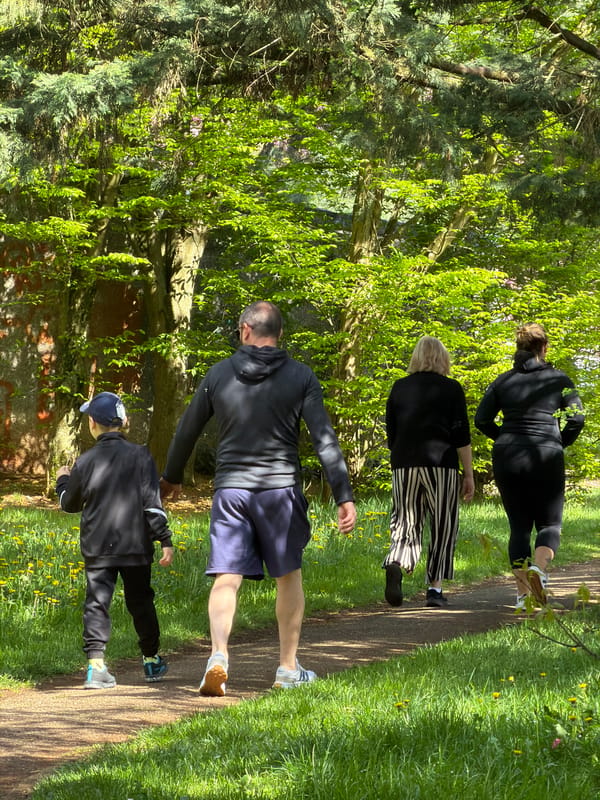 Park visitors walk and jog in Esch-sur-Alzette on sunny afternoon