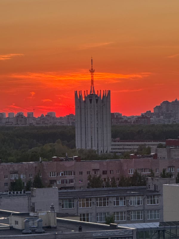 Vibrant sunset illuminates Saint Petersburg skyline with orange-red colors