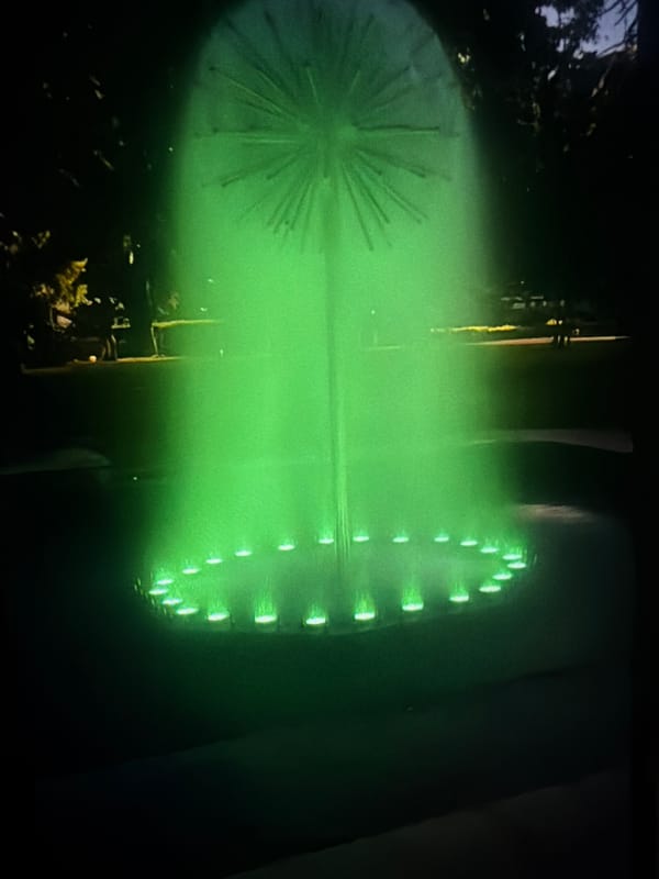 Pleven fountain glowing green after dark