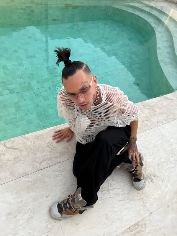 Poolside hang at a white villa with a black dog