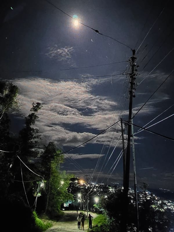 Dubno, Ukraine at night — streets, buildings, and moonlit sky