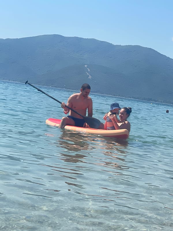 Family enjoys morning beach activities in Nea Vrasna, Greece