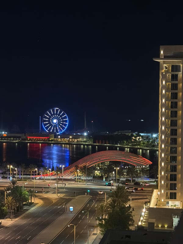 Lusail waterfront at night, Ferris wheel glowing over the bay