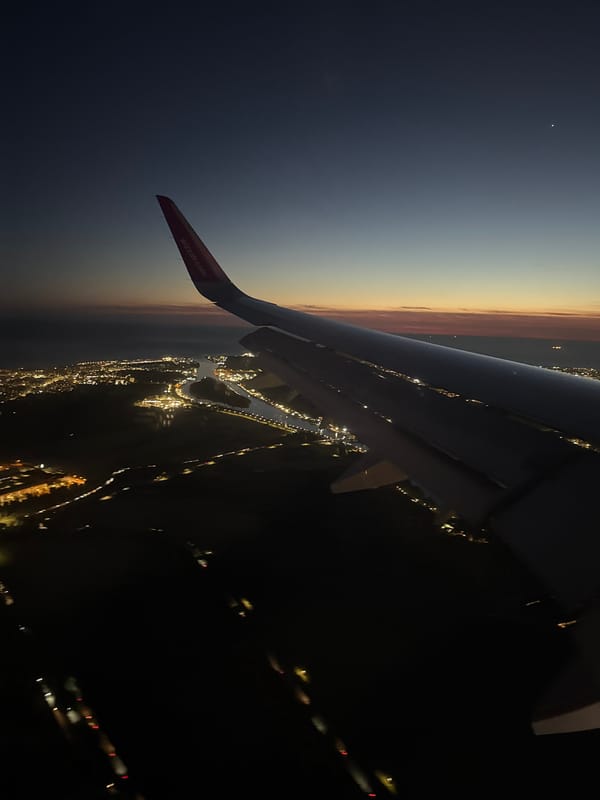 Wizz Air passenger documents evening flight over illuminated Rome