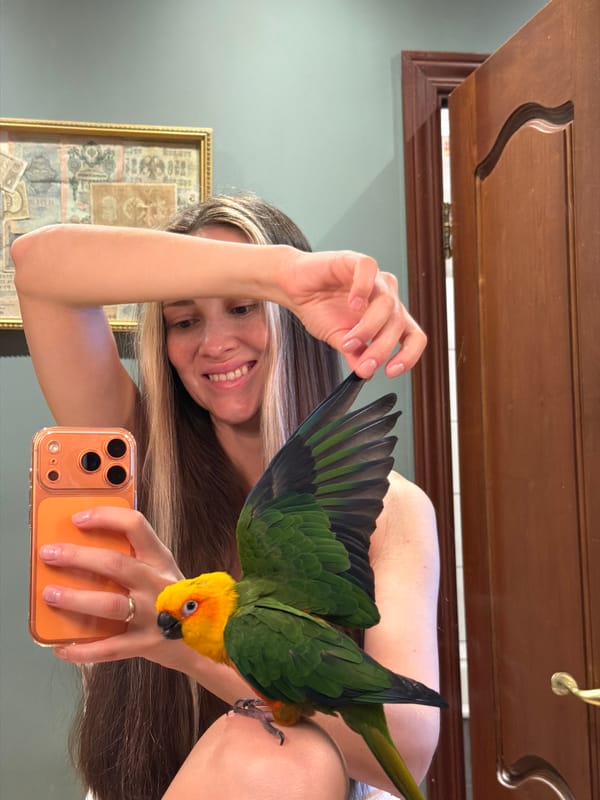 Woman photographs pet parrot session in Khimki suburb