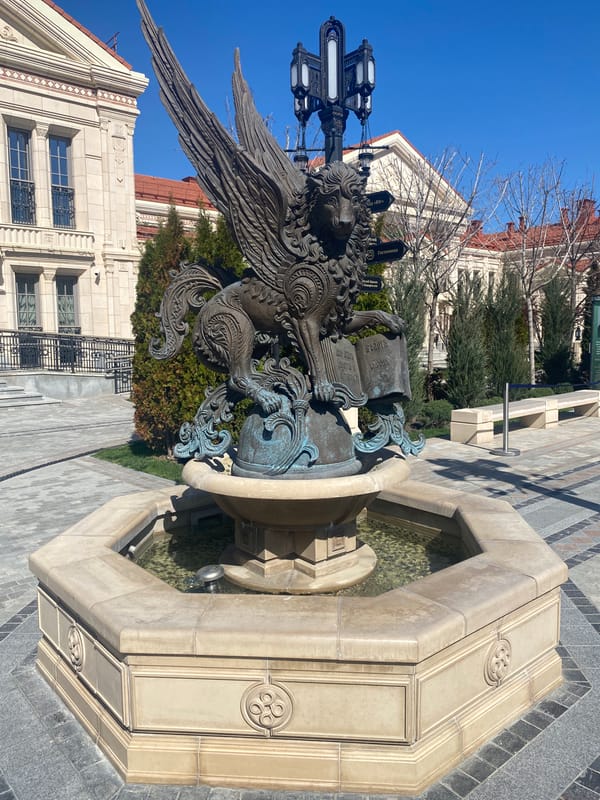 Family visits ornate fountain square in Sevastopol on sunny morning