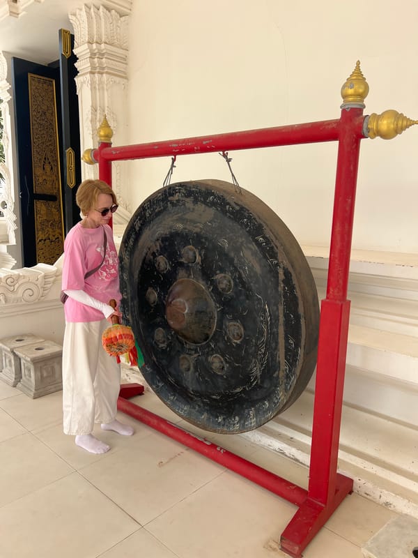 Temple visitors experience Buddhist rituals and sacred art in Thailand