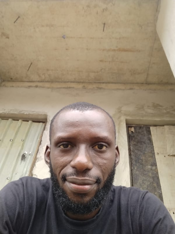 Low-angle selfie, close crop, beard and buzz cut.