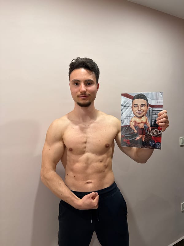 Athletic man photographed indoors against plain wall