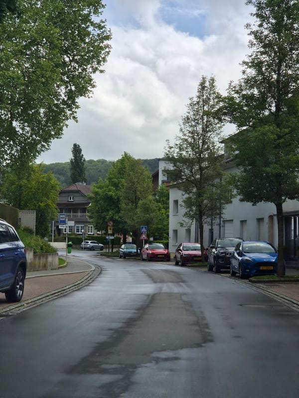 Wet streets reflect cloudy skies in Differdange after rain