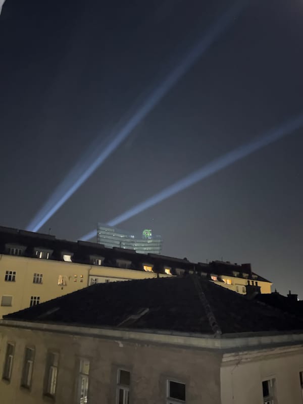 Bright light beams rise over Vienna's night skyline
