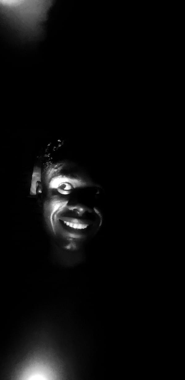 Person photographed smiling upward in nighttime Narayi, Nigeria