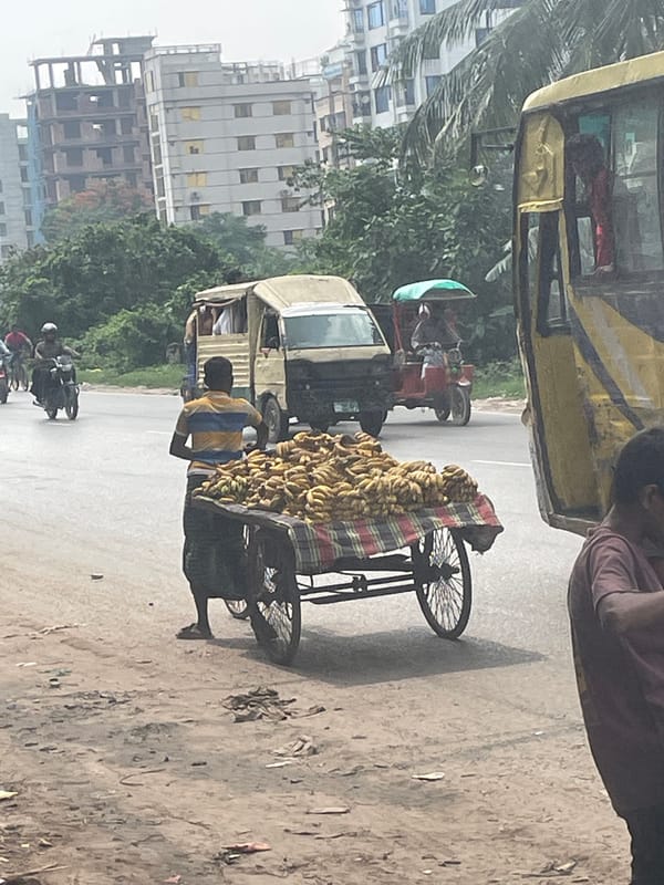 Banana vendor operates cart on Dhaka street