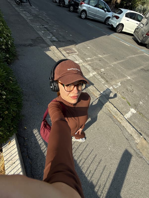Woman takes selfies in brown tracksuit on Sanremo street
