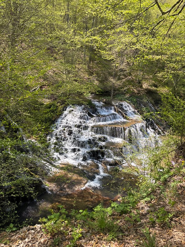 Rural waterfall and traditional houses documented in Stoilovo, Bulgaria