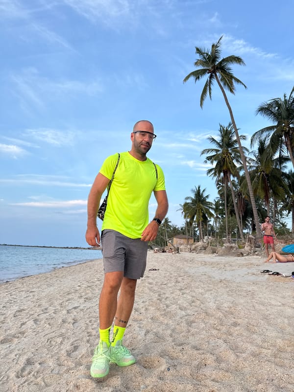Sunset hour on a Ko Samui beach, neon gear and a stray dog