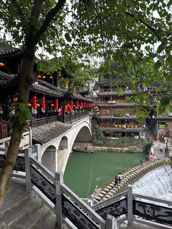 Tourists document scenic Furong Ancient Town river views