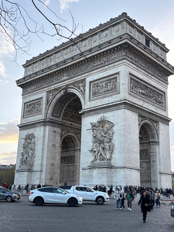 Tourist documents Arc de Triomphe from street level perspectives