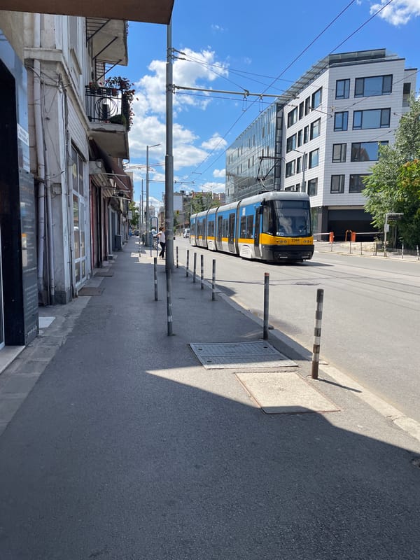 Blue tram rolling through sunny Sofia streets