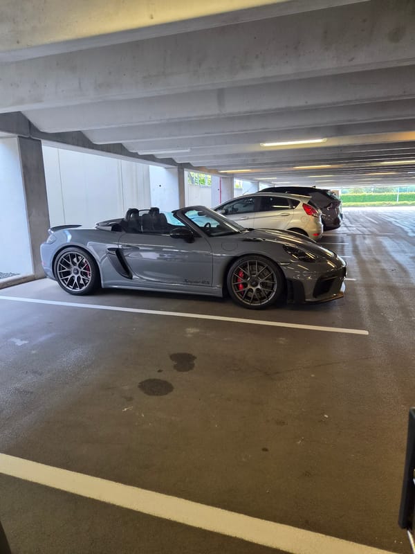 Gray Porsche spotted at Luxembourg parking garage near power lines