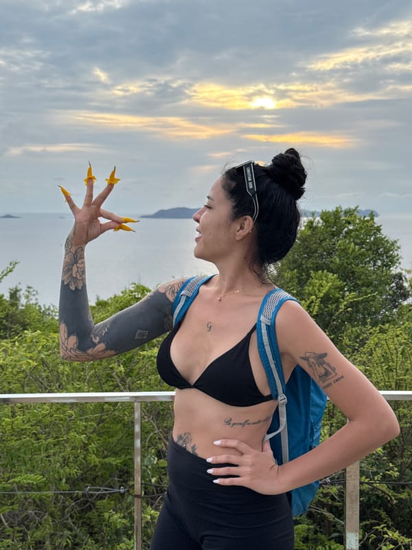 Woman enjoys sunset vista in Pattaya with backpack
