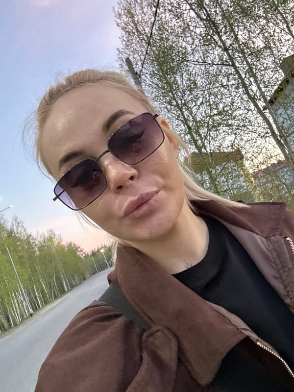 Woman takes selfies during outdoor walk in Высокий, Russia