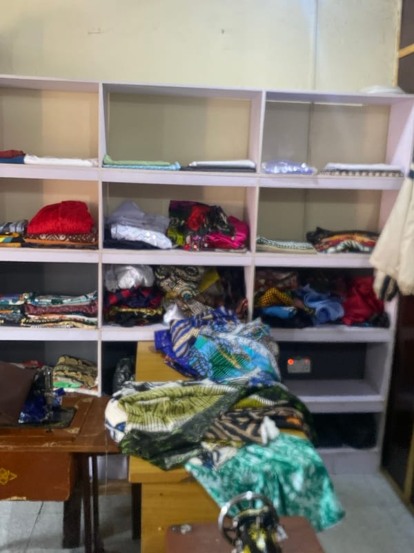 Morning street life and textile commerce in Bukuru, Nigeria