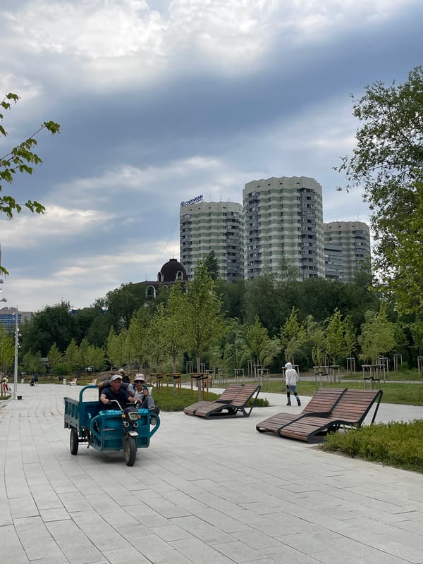 Almaty lakeside park buzzes with visitors and groundskeeping crews