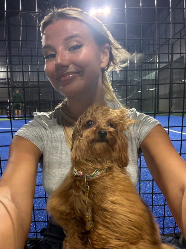 Courtside hangout with a fluffy dog at a Thep Krasatti padel club