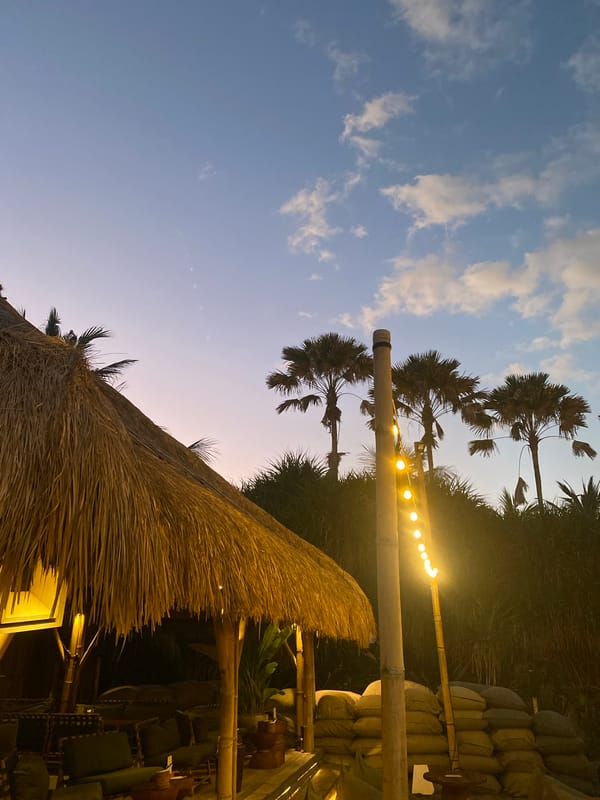 North Kuta beach bar strip at dusk, lights coming on