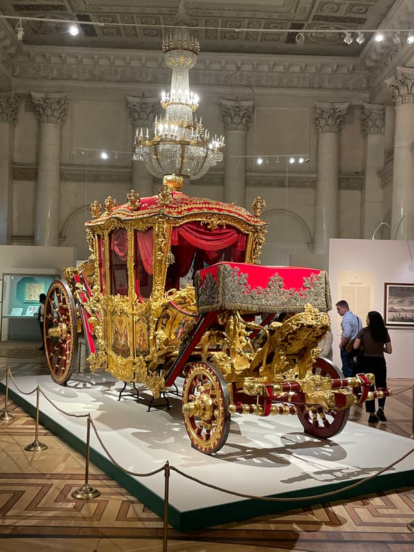 Historic ornate carriage displayed in unknown museum