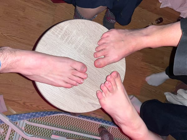 Three people gather barefoot around table in Strasbourg