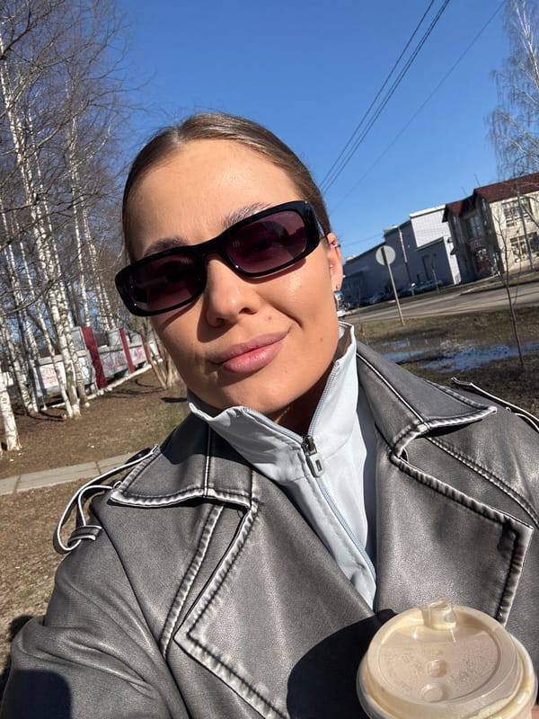 Woman with coffee cup spotted on sunny street in Chernushka