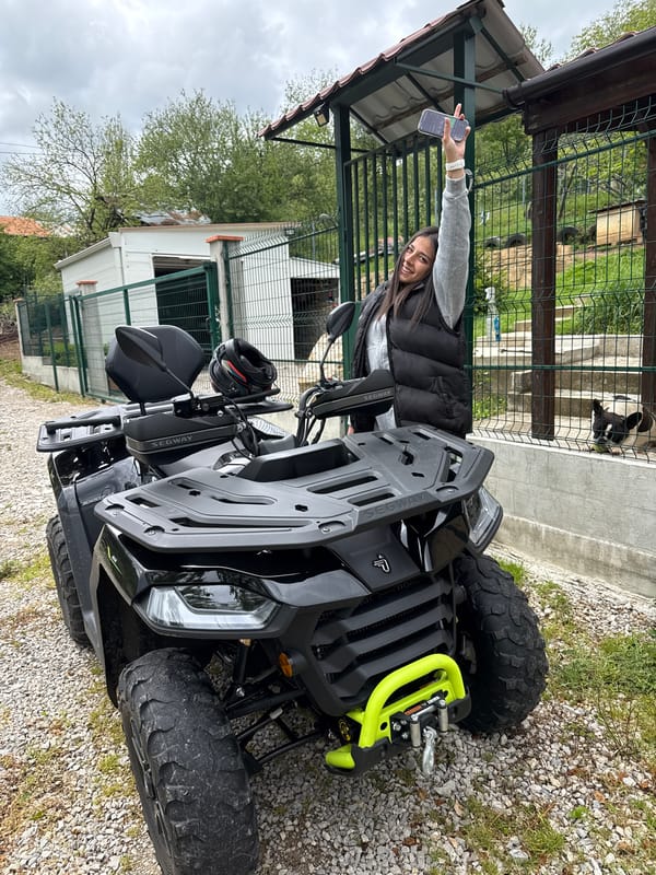 Woman enjoys ATV ride with dog in Bulgarian village