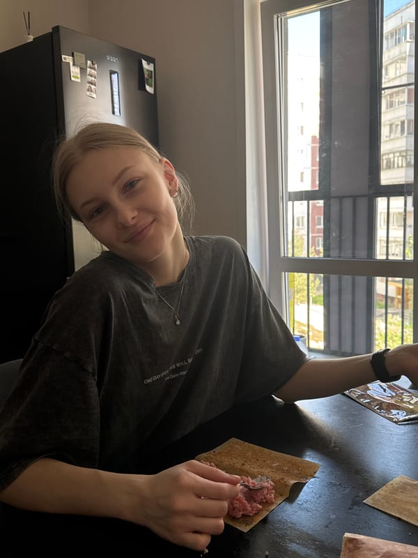 Woman prepares breakfast crackers in Perm apartment kitchen
