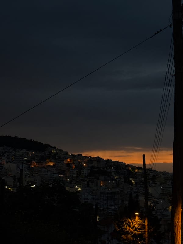 Dramatic sunset captured over hillside city of Kavala, Greece