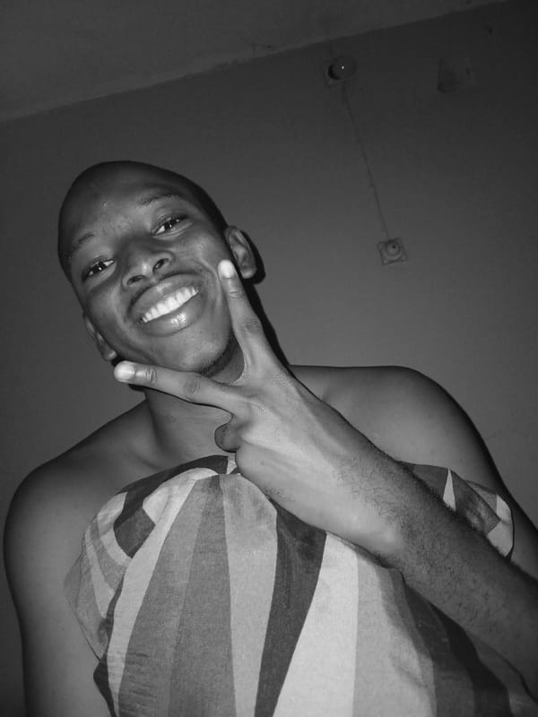 Goofing around in bed, sunglasses on, Lagos bedroom