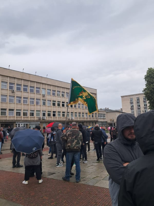 Crowd gathers in rainy Gabrovo square near school