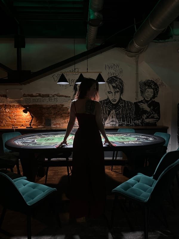 Woman at poker table in Vladimir bar with music murals
