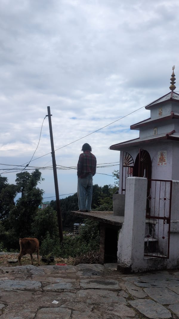 Person visits small temple in Haini during overcast morning