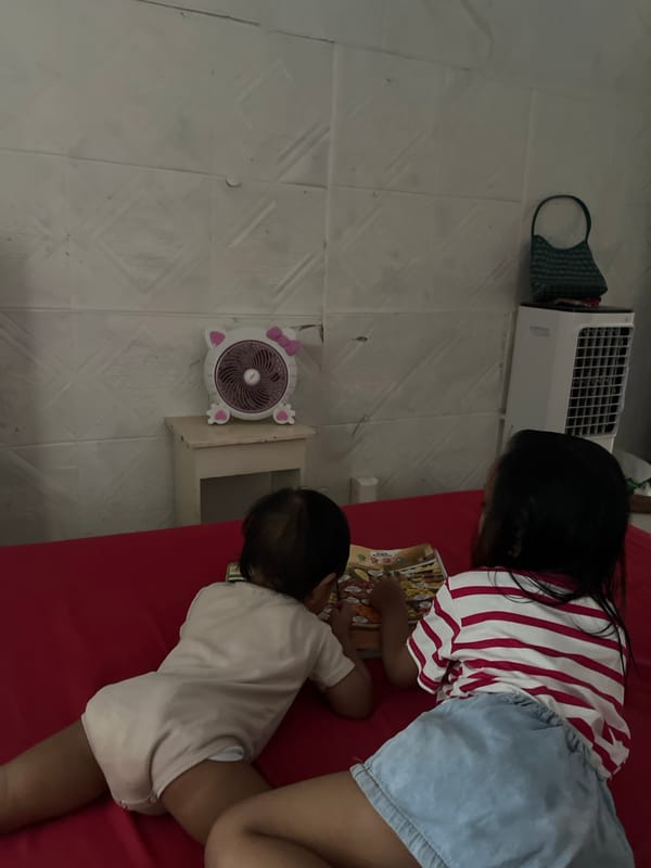 Kids reading and playing games on a red bed, selfies nearby