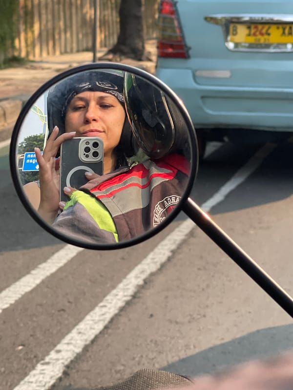 Motorcycle mirror selfie on the streets of Central Jakarta