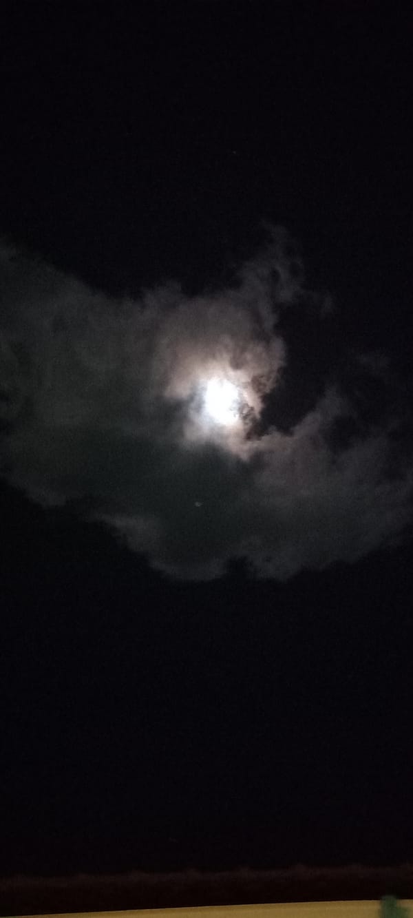 Moon observed through clouds over Baan Chaloklum, Thailand