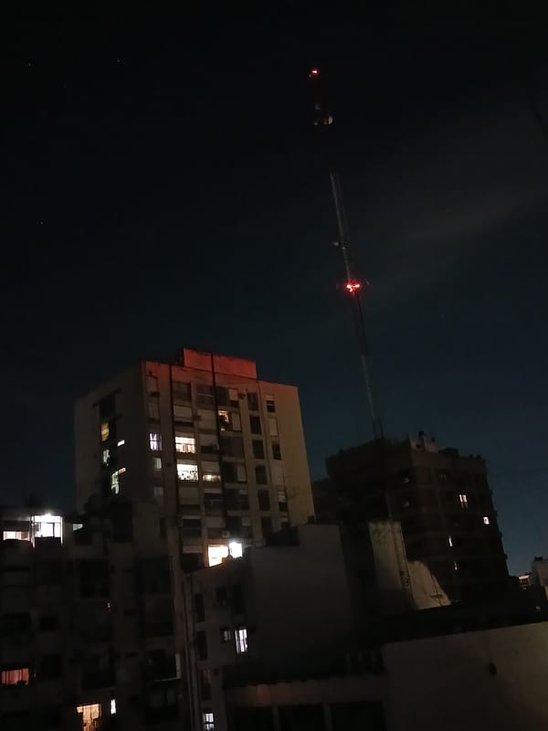 Person photographed in red lighting during Buenos Aires night