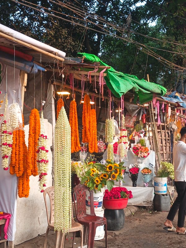 Flower vendor tends colorful outdoor stall in Dhaka