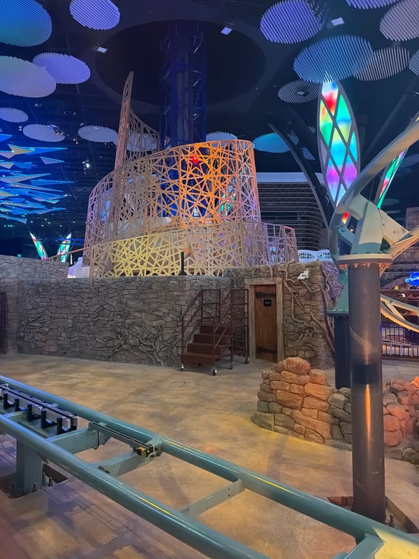 Indoor roller coaster winds through an ancient-themed attraction