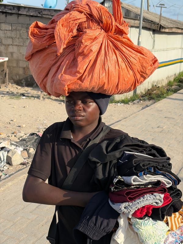 Residents carry belongings through Igboefon, Nigeria