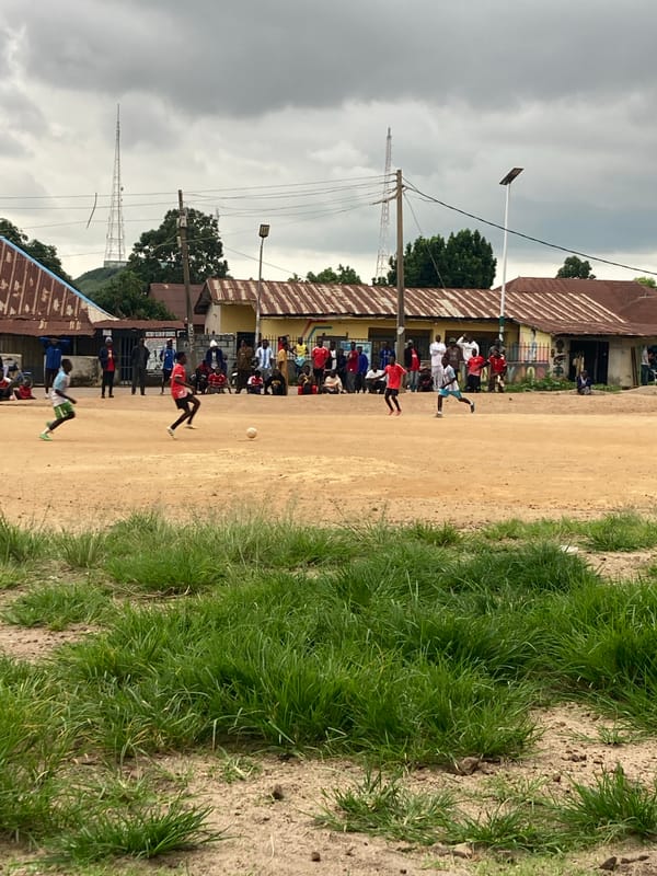 Pickup soccer on a dirt field in Jos, Nigeria