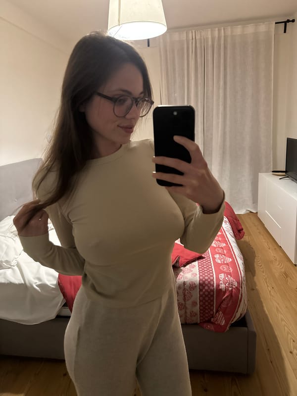 Woman takes multiple selfies indoors in Sappada, Italy