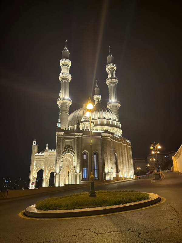 Baku night: mosque, wet streets, and a city bus